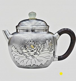 Fine sterling silver handcrafted teapot with plant relief £1500 order number 880. This teapot is placed in the hands of the son to place in God the Father's hands. Signed FrancesJHenry